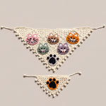 Cream crochet bandana set with five cat faces and a black paw, plus a small orange-paw cat bandana, laid flat — handmade by Ana Chic