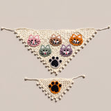 Cream crochet bandana set with five cat faces and a black paw, plus a small orange-paw cat bandana, laid flat — handmade by Ana Chic