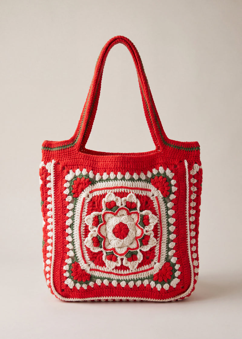 Front of the red crochet tote bag with its raised crocheted medallion — handmade by Ana Chic