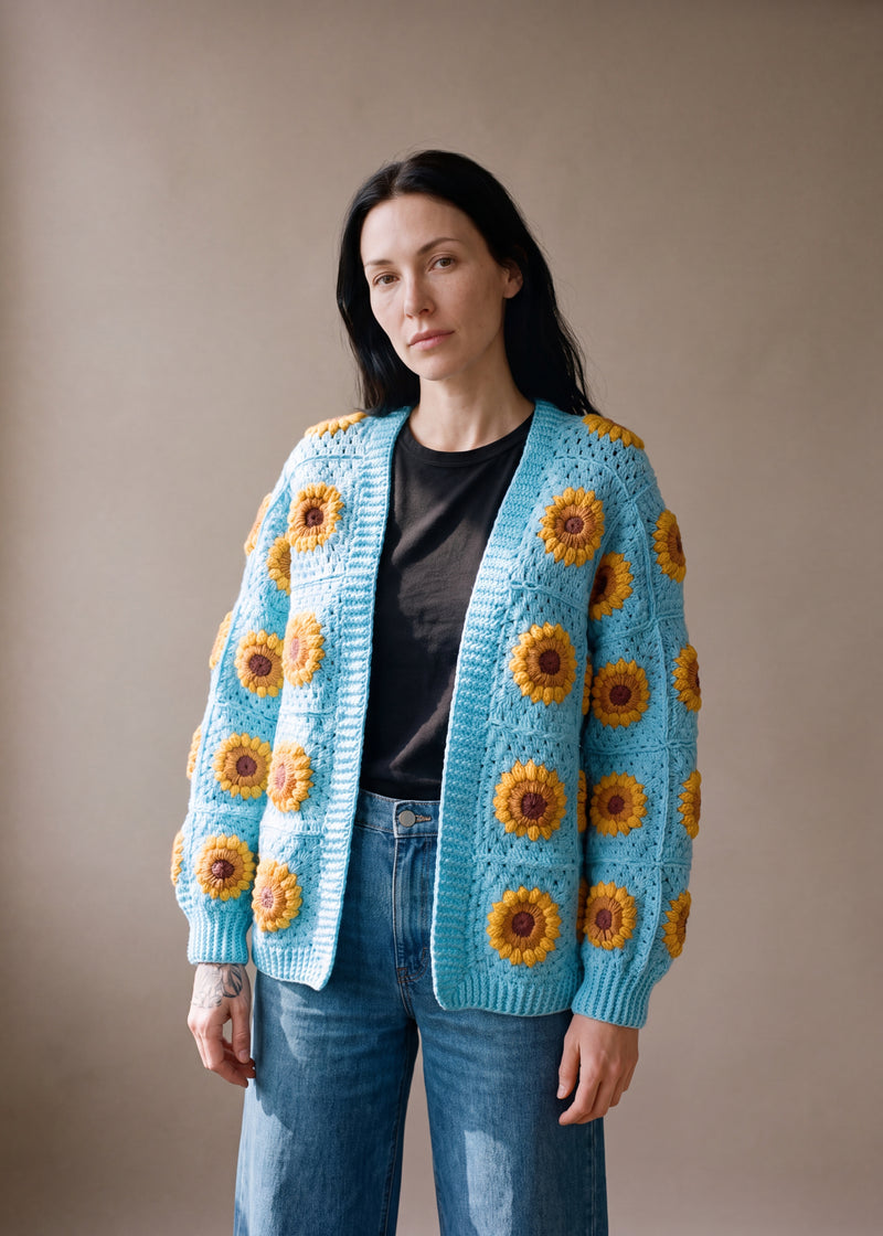 3D Sunflower Turquoise Cardigan - bright turquoise crocheted granny square cardigan with raised crochet sunflowers, worn by Ana Chic