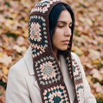Brown granny-square crochet hooded scarf worn with the hood up and the tails down the front — handmade by Ana Chic