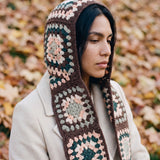 Brown granny-square crochet hooded scarf worn with the hood up and the tails down the front — handmade by Ana Chic