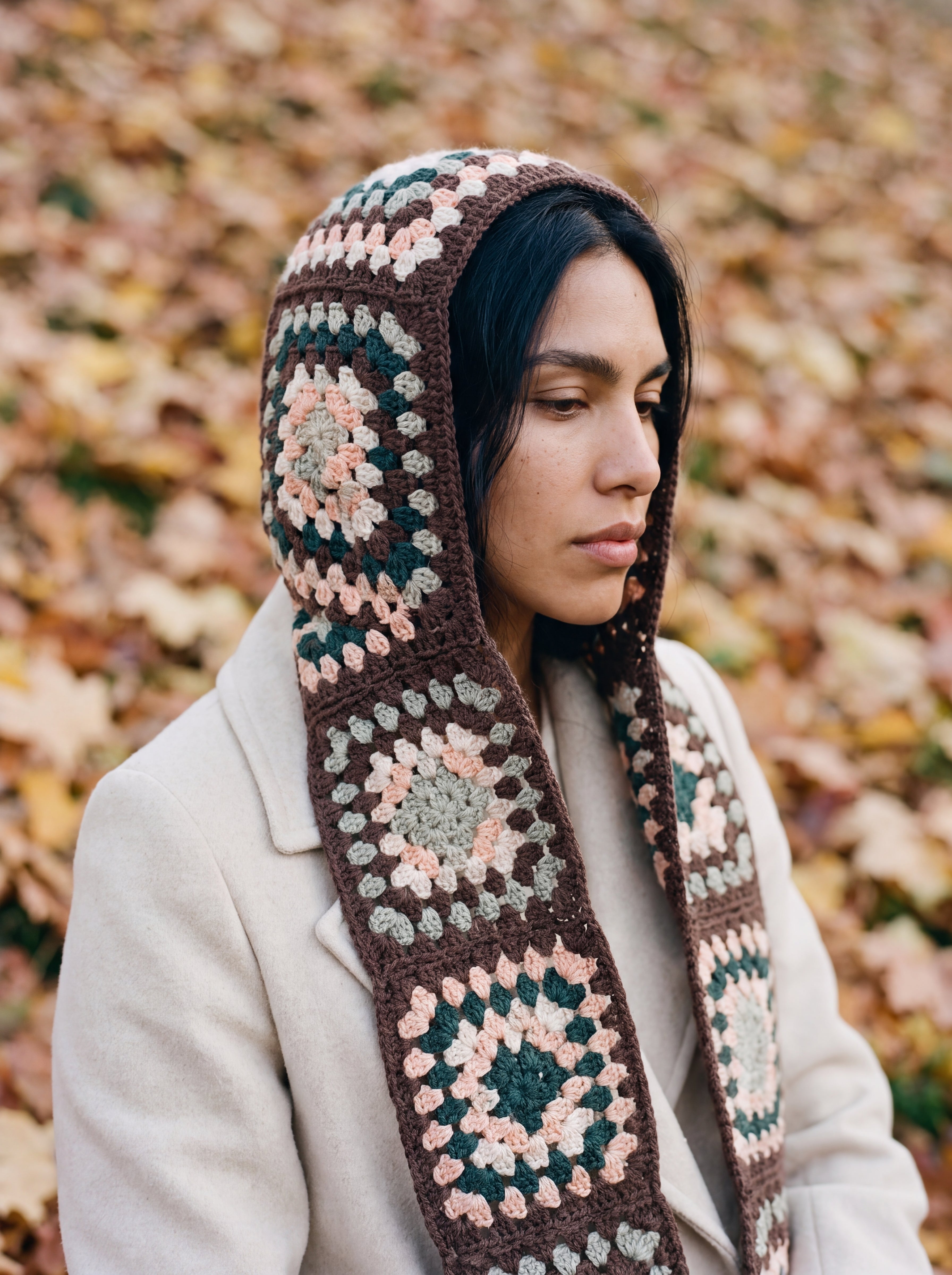 Brown granny-square crochet hooded scarf worn with the hood up and the tails down the front — handmade by Ana Chic