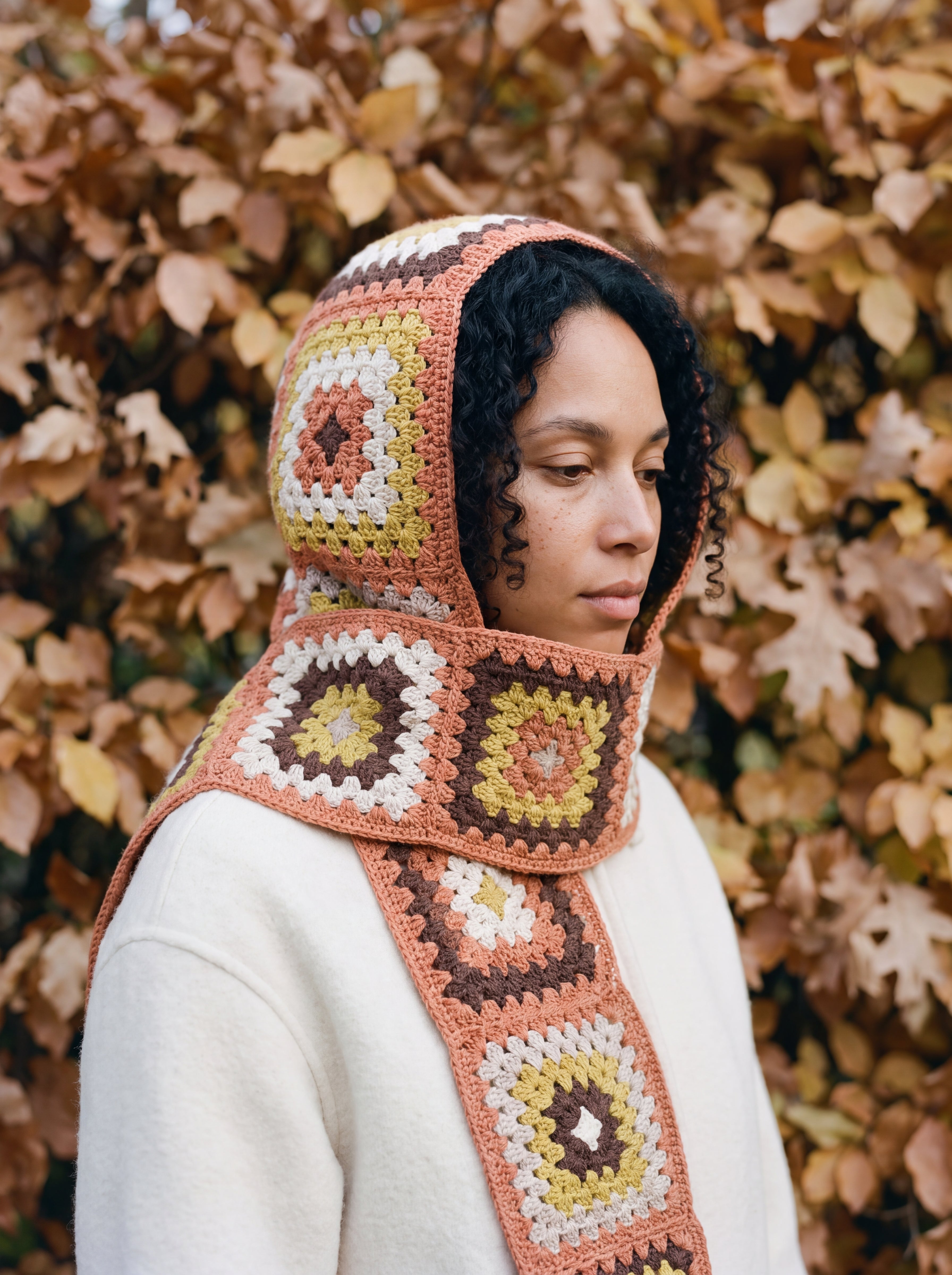 Terracotta granny-square crochet hooded scarf worn with the hood up and the tails down the front — handmade by Ana Chic