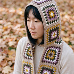 Taupe granny-square crochet hooded scarf worn with the hood up and the tails down the front — handmade by Ana Chic