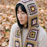 Taupe granny-square crochet hooded scarf worn with the hood up and the tails down the front — handmade by Ana Chic