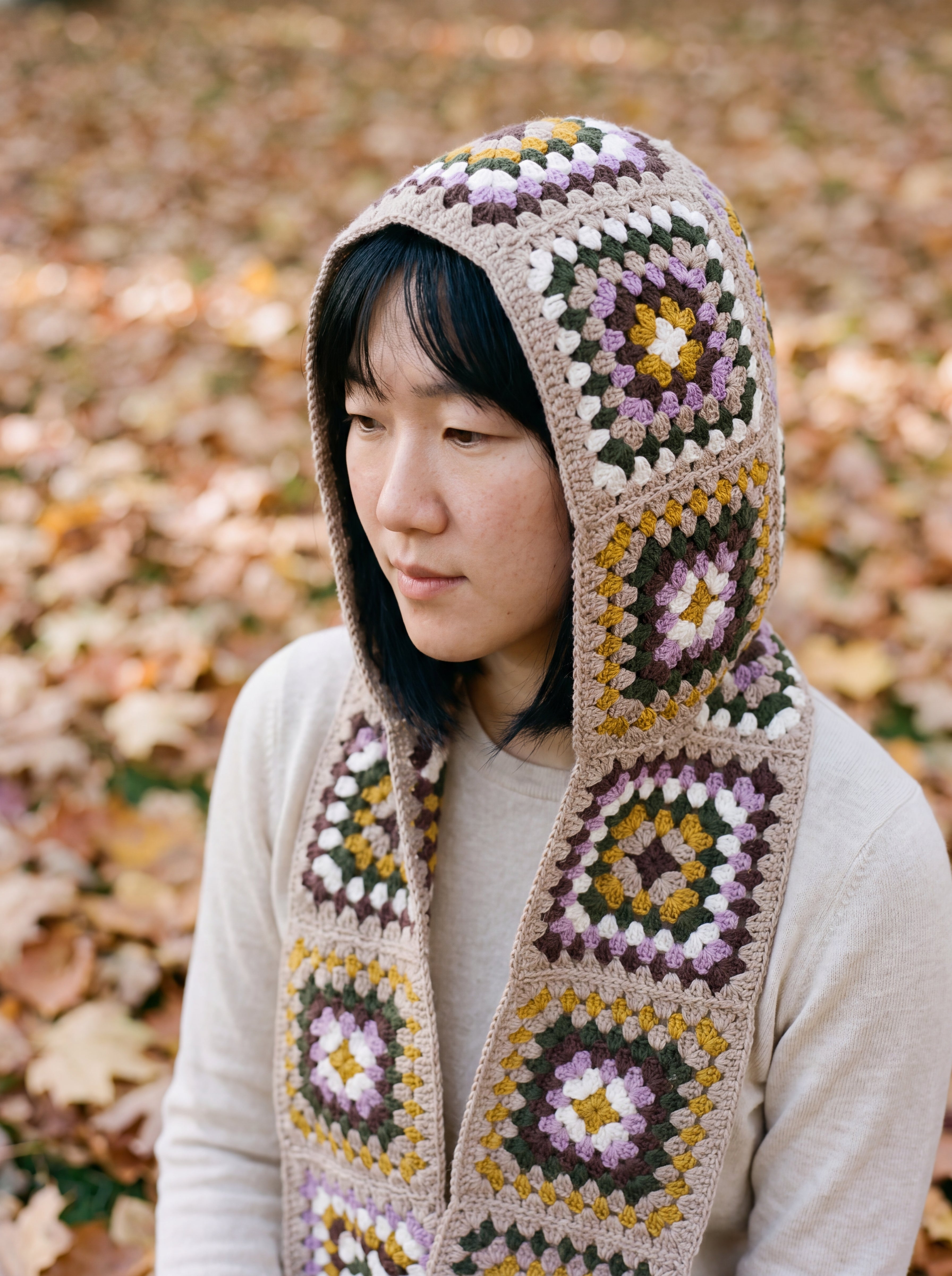 Taupe granny-square crochet hooded scarf worn with the hood up and the tails down the front — handmade by Ana Chic
