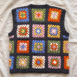 Multicolour granny square crochet vest, back, laid flat on linen