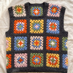 Multicolour granny square crochet vest, front, laid flat on linen