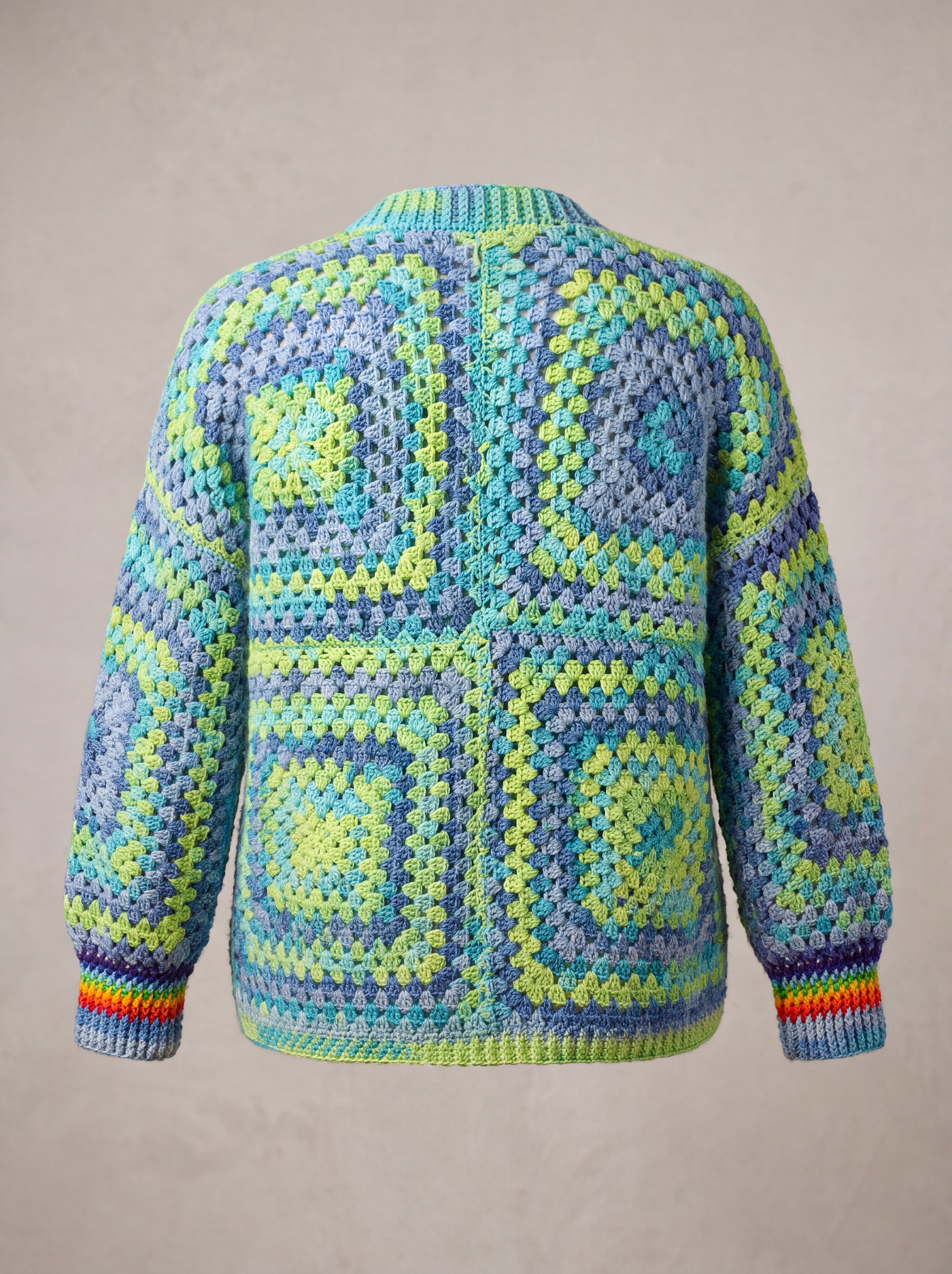 Back of a lime, aqua and denim-blue granny square cardigan with rainbow cuffs — handmade by Ana Chic