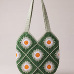 Back of the green crochet shoulder bag with its daisy granny squares and two shoulder straps — handmade by Ana Chic