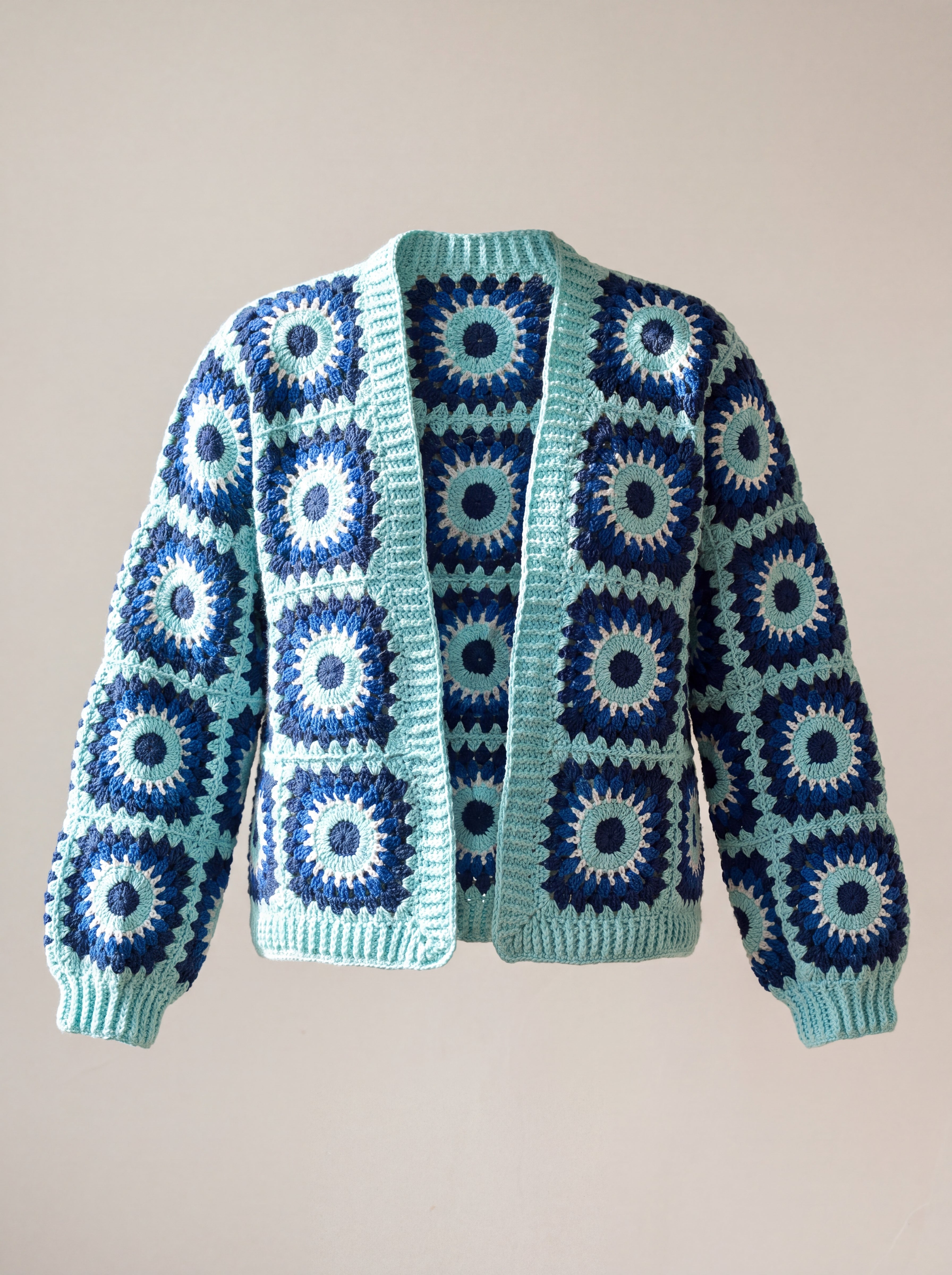 Front of the navy and aqua Ribbed Cuff Cardigan, navy squares with aqua rings and white stitch fringes - handmade by Ana Chic