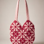 Front of the pink crochet shoulder bag with pale pink daisy granny squares on raspberry red and two wide straps — handmade by Ana Chic