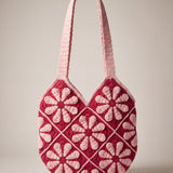 Front of the pink crochet shoulder bag with pale pink daisy granny squares on raspberry red and two wide straps — handmade by Ana Chic