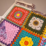 Close-up of the Bouquet Button Vest: hand-crocheted squares, each one a different design