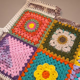 Close-up of the Bouquet Button Vest: hand-crocheted squares, each one a different design