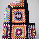 Black pastel granny square balaclava laid flat, side view of the hood — handmade by Ana Chic