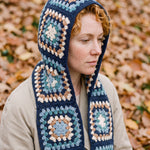 Navy granny-square crochet hooded scarf worn with the hood up and the tails down the front — handmade by Ana Chic