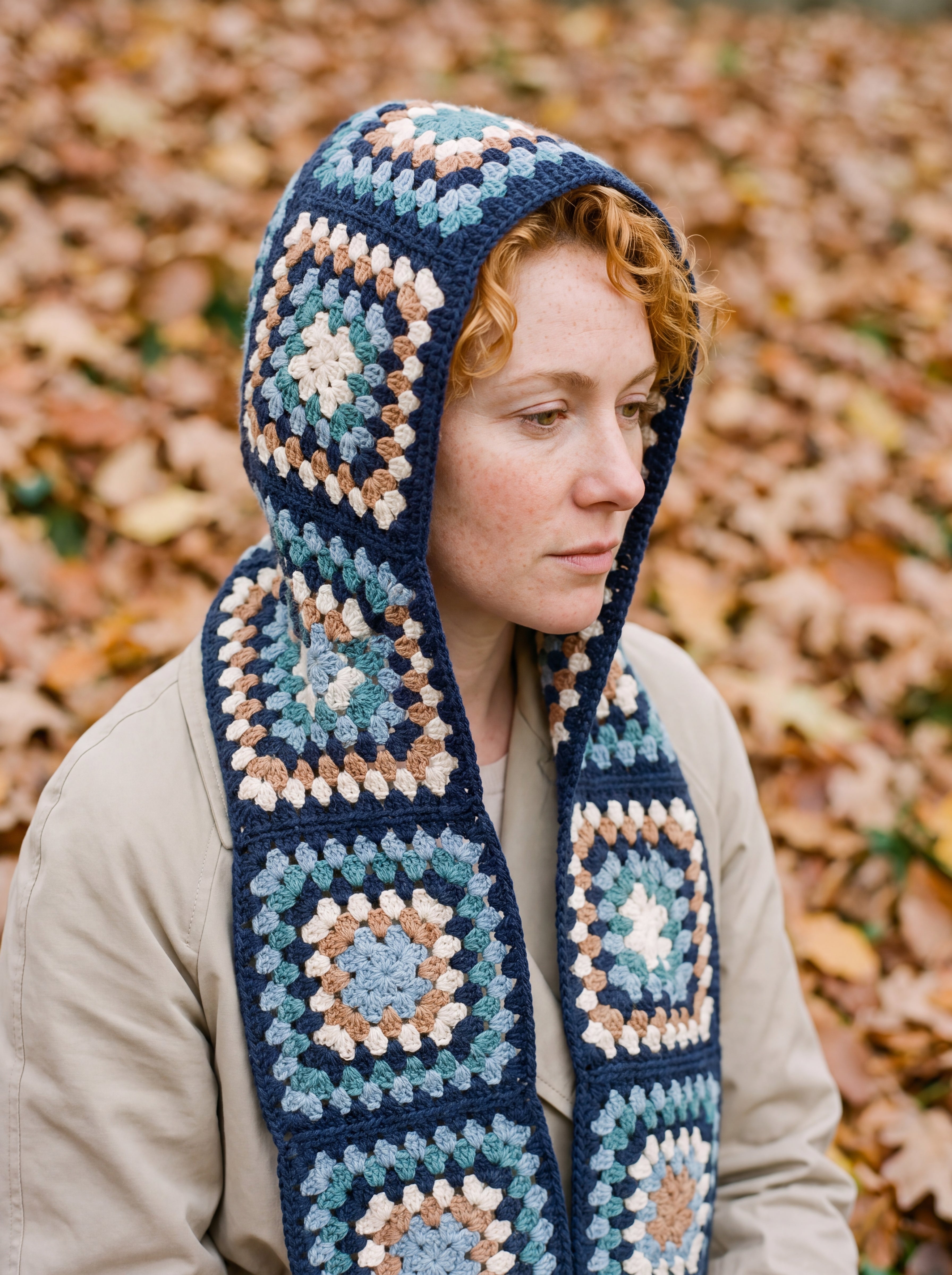 Navy granny-square crochet hooded scarf worn with the hood up and the tails down the front — handmade by Ana Chic