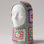 Sage multicolour granny square balaclava on a display head, open face and deep neck section — handmade by Ana Chic
