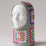 Sage multicolour granny square balaclava on a display head, open face and deep neck section — handmade by Ana Chic
