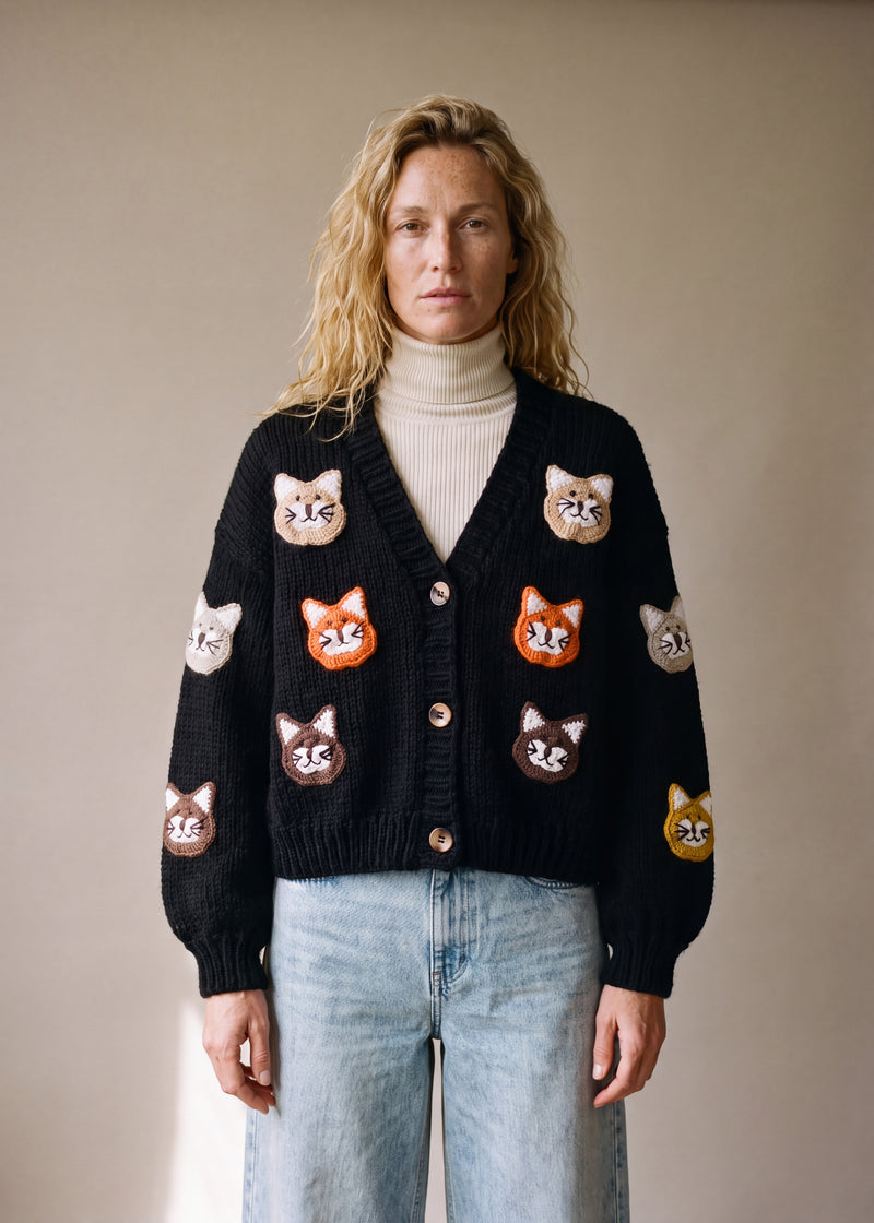 Cat  – Chunky Wool Hand-Knitted Cardigan - black chunky hand-knitted wool cardigan with crocheted motifs, worn open over a plain top by Ana Chic