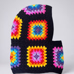Black rainbow granny square balaclava laid flat, side view of the hood — handmade by Ana Chic