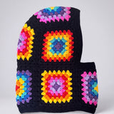 Black rainbow granny square balaclava laid flat, side view of the hood — handmade by Ana Chic