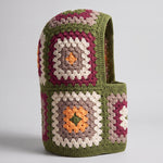 Olive green granny square balaclava standing on its own, back view of the hood — handmade by Ana Chic
