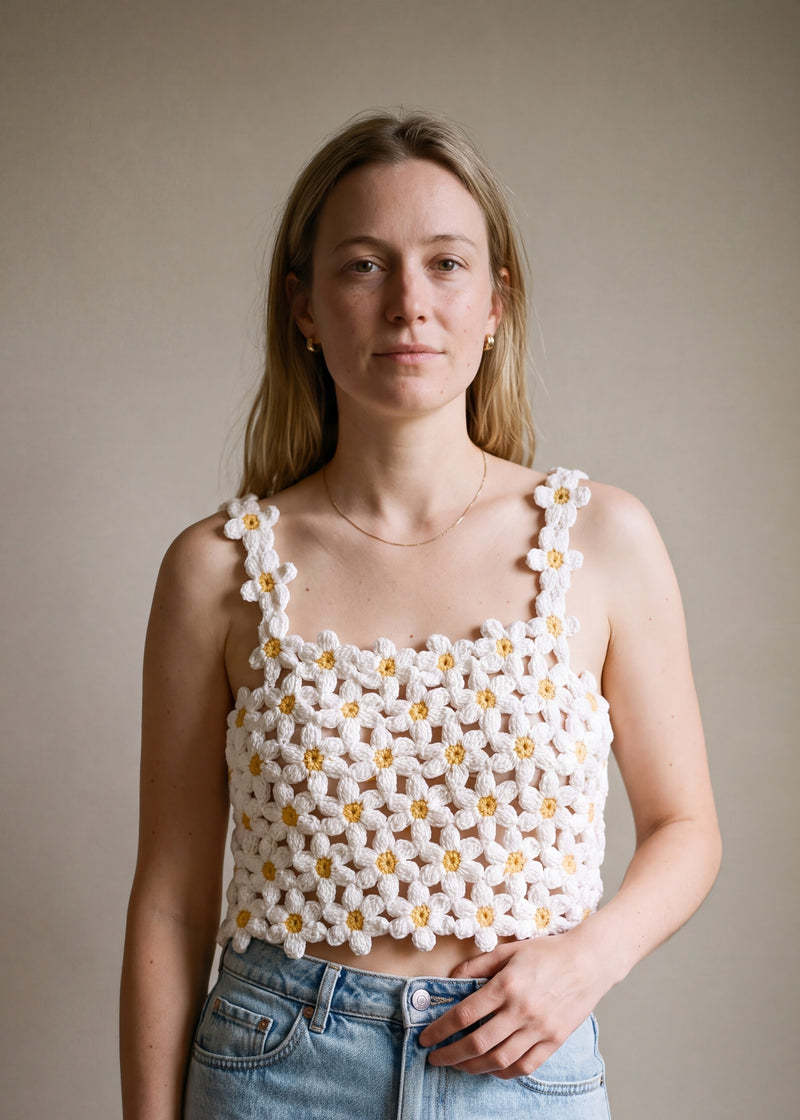 Woman wearing the Daisy crochet crop top on bare skin with a denim mini skirt