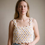 Woman wearing the Daisy crochet crop top on bare skin with a denim mini skirt