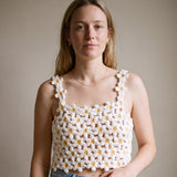 Woman wearing the Daisy crochet crop top on bare skin with a denim mini skirt