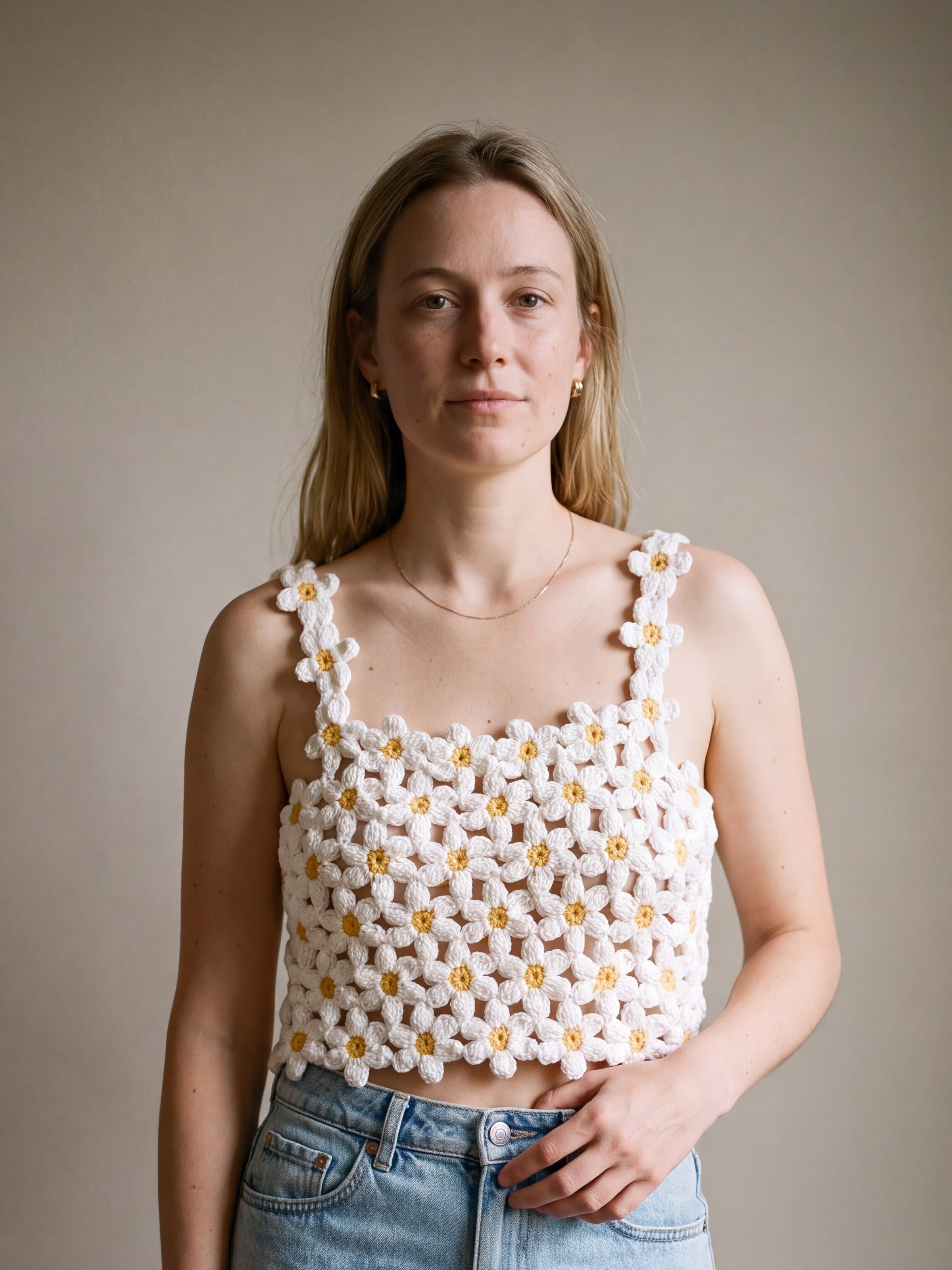 Woman wearing the Daisy crochet crop top on bare skin with a denim mini skirt