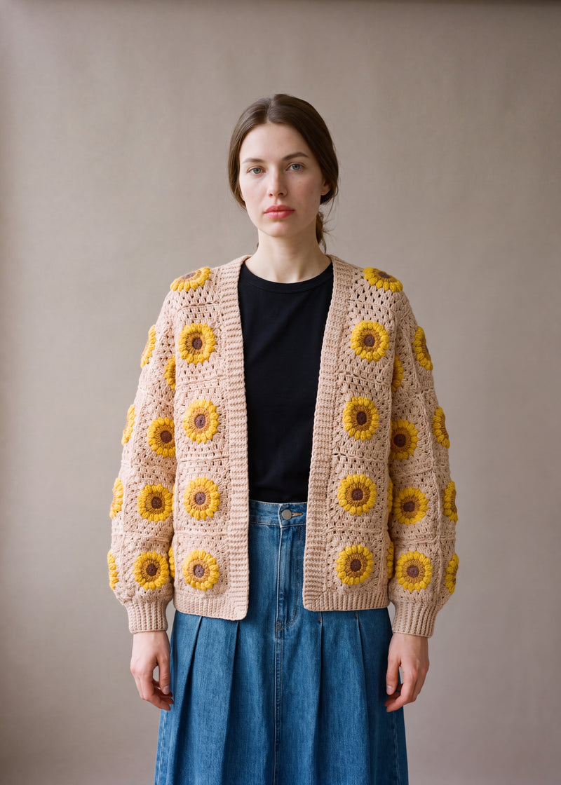 Sunflower Cardi – Beige - Warm oatmeal-sand crocheted crocheted granny square cardigan with raised crochet sunflowers, worn by Ana Chic
