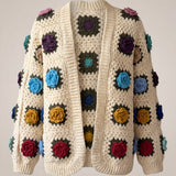 Cream granny-square cardigan with raised multicolour crochet roses, open front and softly full sleeves gathered into ribbed cuffs — handmade by Ana Chic
