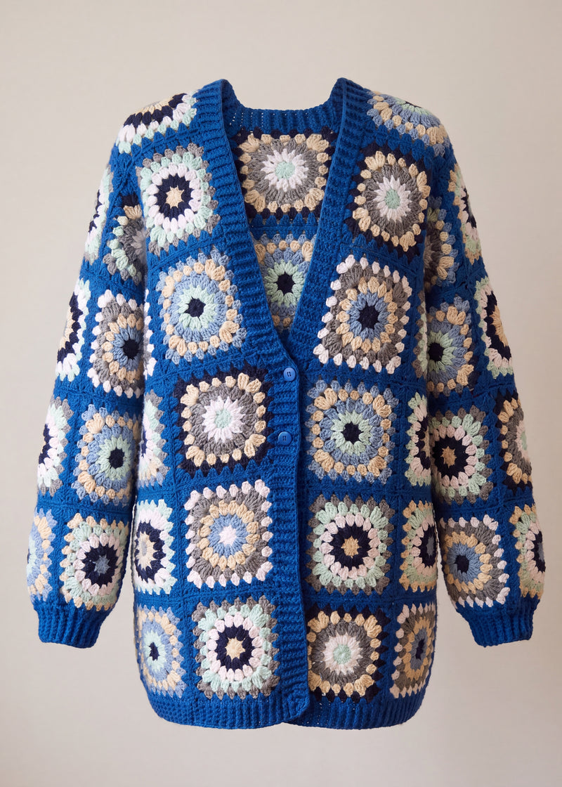 Oversized royal blue granny-square cardigan with cream and camel sunburst centres, front view - handmade by Ana Chic