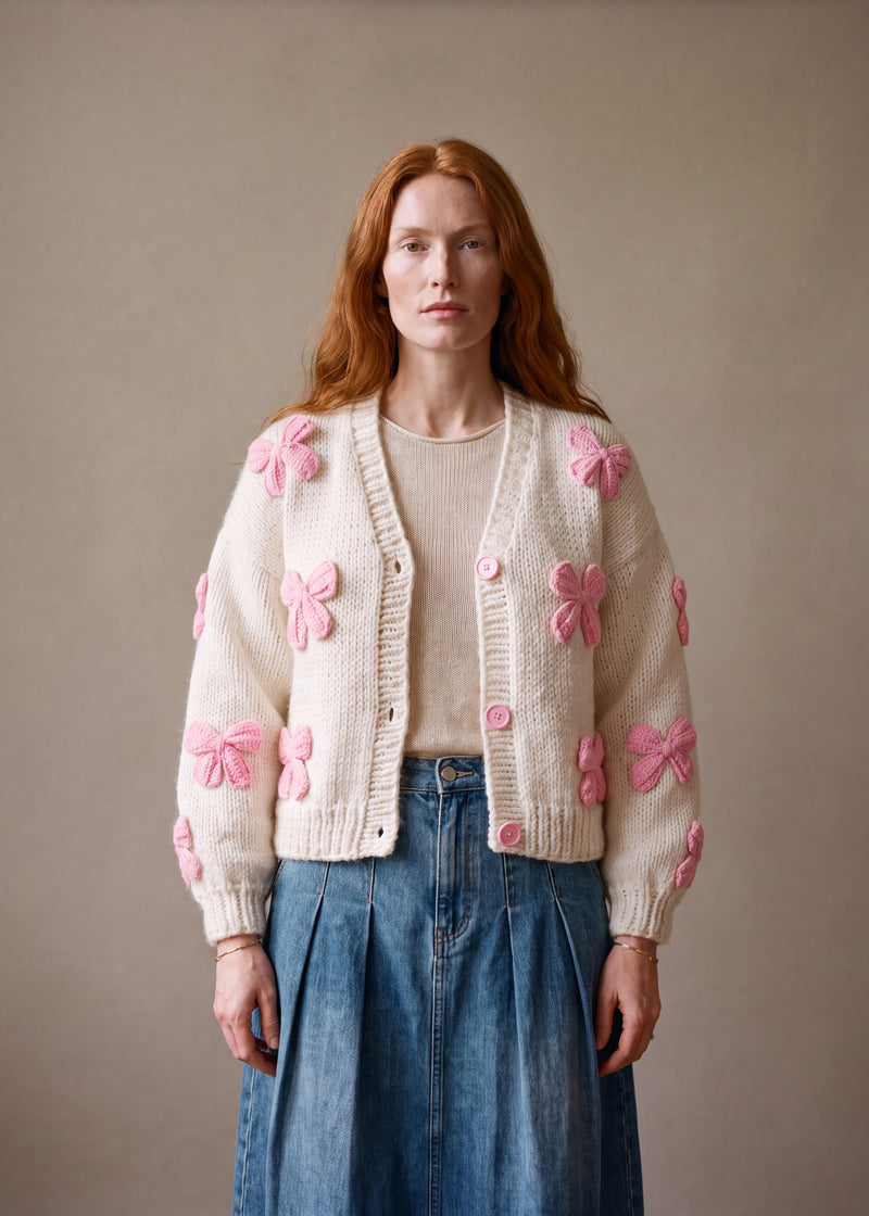 Pink Bow Knit Cardigan - cream chunky hand-knitted wool cardigan with crocheted motifs, worn open over a plain top by Ana Chic