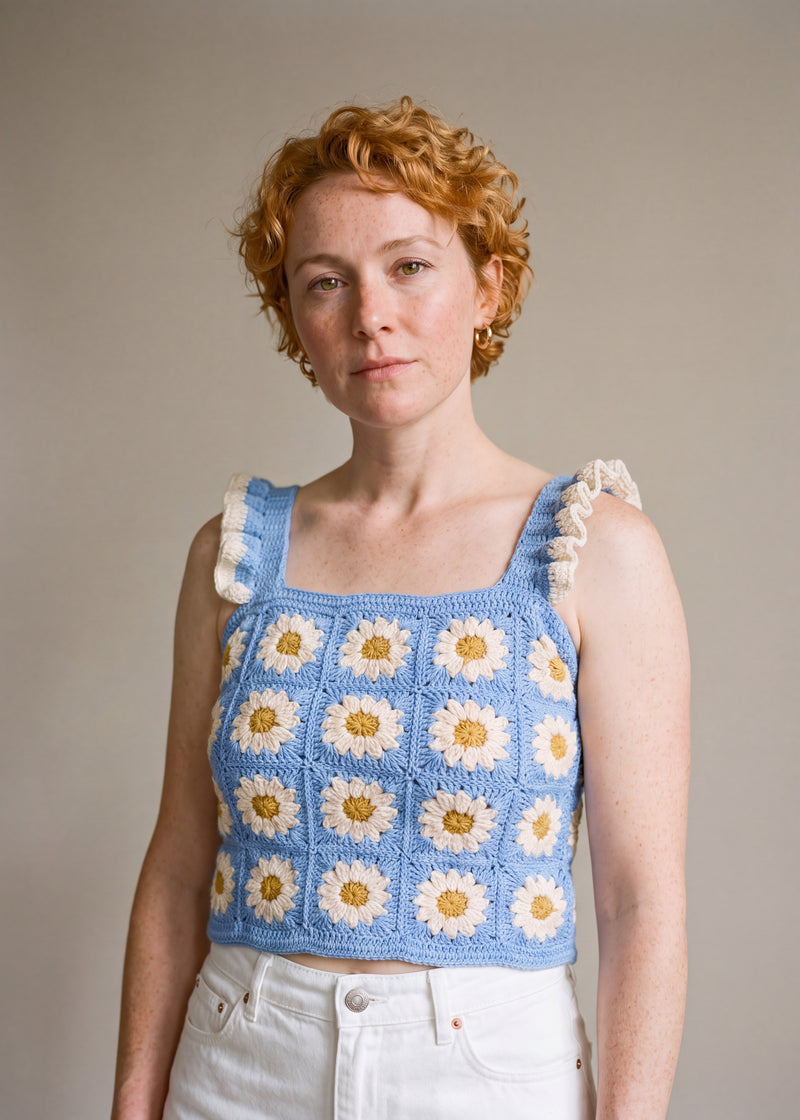 Blue Daisy Crochet Top worn with a white denim skirt, cream daisy granny squares and ruffle straps — handmade by Ana Chic