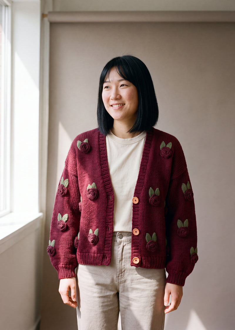 Burgundy Rose Knit Cardigan - deep burgundy chunky hand-knitted wool cardigan with crocheted motifs, worn open over a plain top by Ana Chic