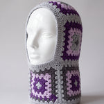 Grey and purple granny square balaclava on a display head, open face and deep neck section — handmade by Ana Chic