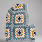 Teal and mustard granny square balaclava laid flat, side view of the hood — handmade by Ana Chic