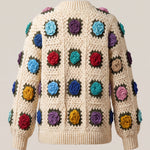 Back of cream granny-square cardigan with a raised crochet rose in every square and a deep ribbed hem — handmade by Ana Chic