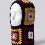 Black and burgundy granny square balaclava on a display head, open face and deep neck section — handmade by Ana Chic