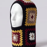 Black and burgundy granny square balaclava on a display head, open face and deep neck section — handmade by Ana Chic