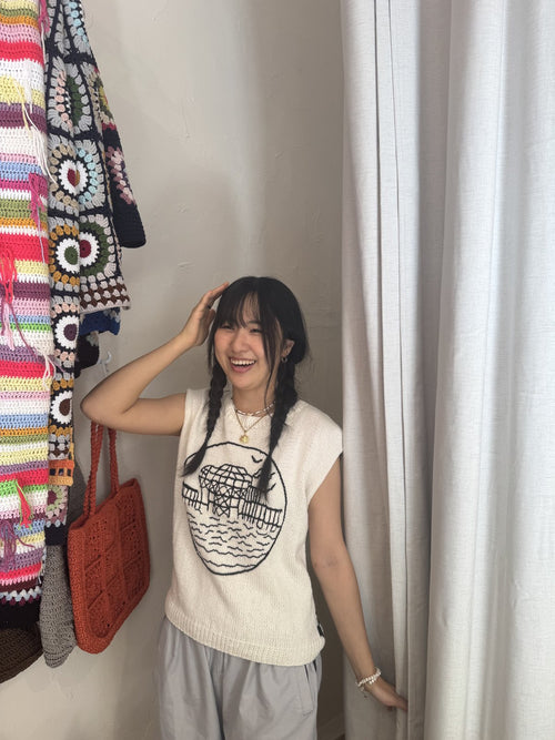 Customer in a white crochet vest