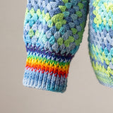 Rainbow-striped ribbed cuff on a granny square crochet cardigan — handmade by Ana Chic