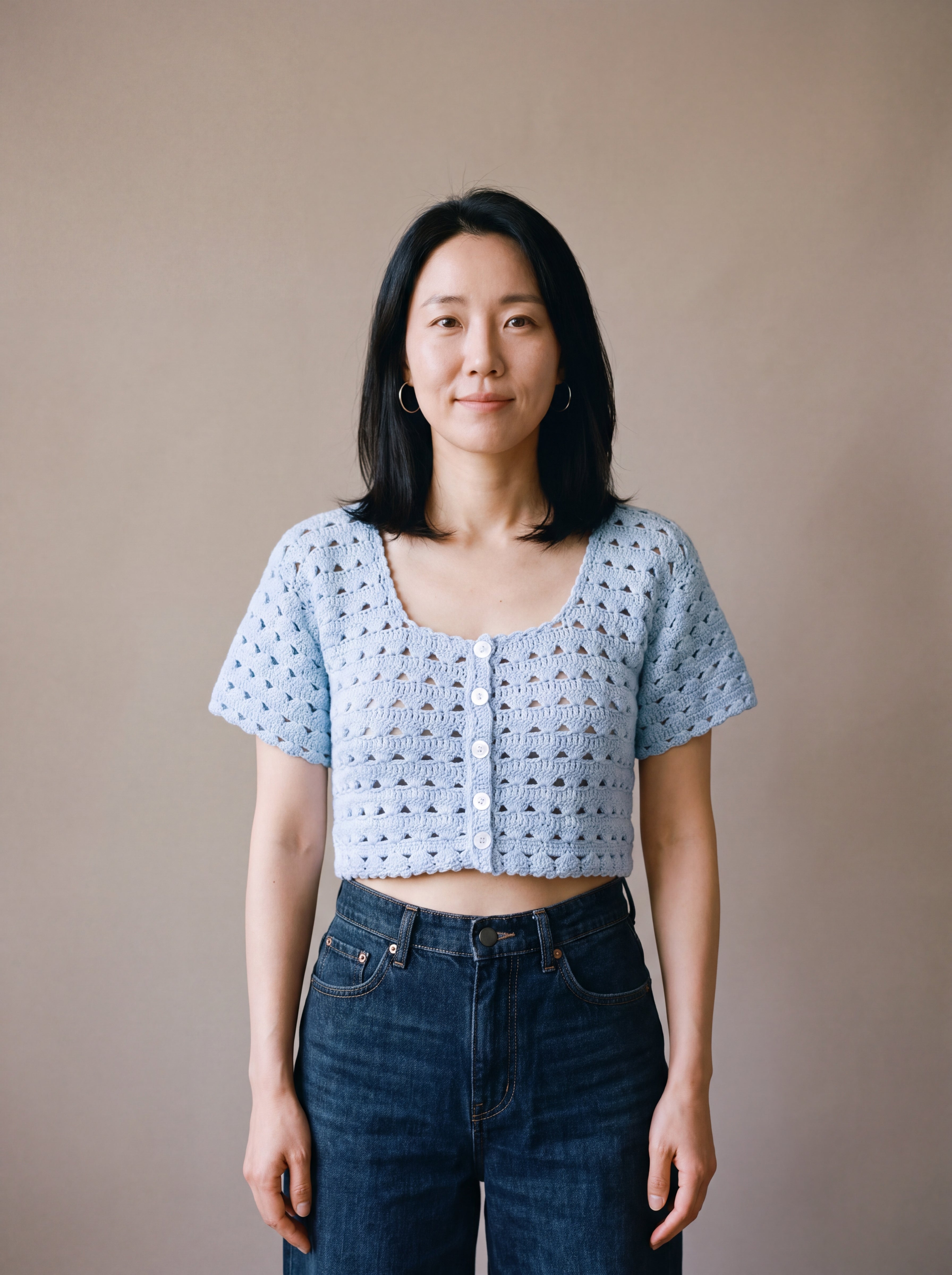 Ivory hand-crocheted organic cotton cropped top in baby blue, worn buttoned with five pearl buttons - Ana Chic