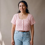 Ivory hand-crocheted organic cotton cropped top in baby pink, worn buttoned with five pearl buttons - Ana Chic