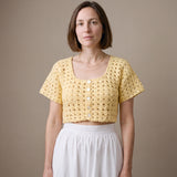 Ivory hand-crocheted organic cotton cropped top in butter yellow, worn buttoned with five pearl buttons - Ana Chic