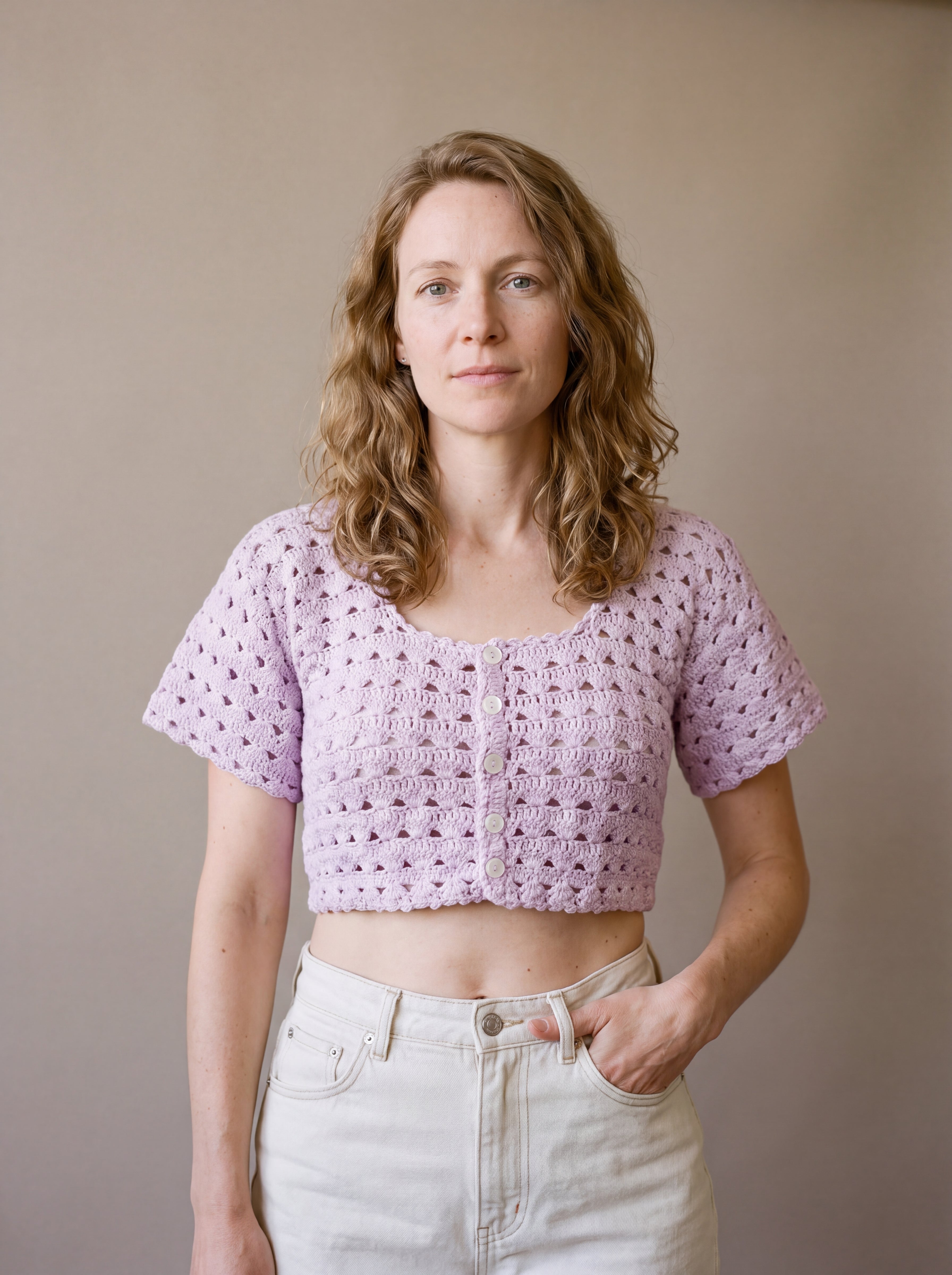 Ivory hand-crocheted organic cotton cropped top in lilac, worn buttoned with five pearl buttons - Ana Chic